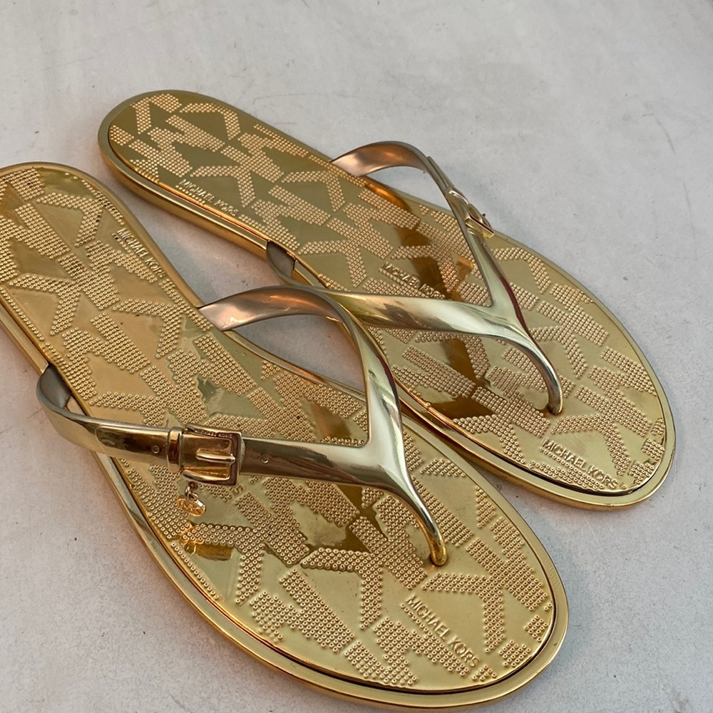 Michael Kors gold flip flops